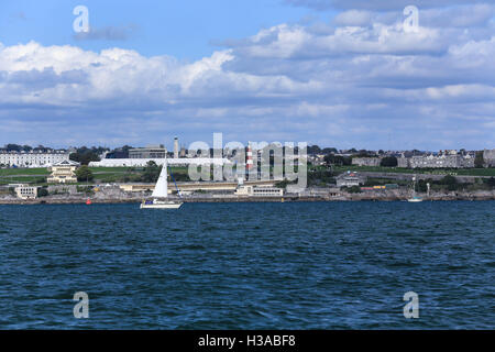 Sailing yacht sailing past Smeatons Tower,Plymouth Hoe,Devon Stock Photo