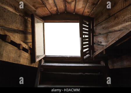 Empty attic window with white background in old grunge wooden interior Stock Photo