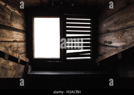 Empty attic window with shutters in old grunge wooden interior Stock Photo