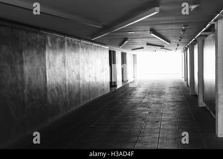 Underpass. Dark abstract underground tunnel interior with glowing end Stock Photo