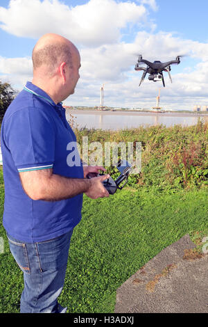 Man flying 3DR RTF X8 drone near River Mersey, Merseyside, England Stock Photo