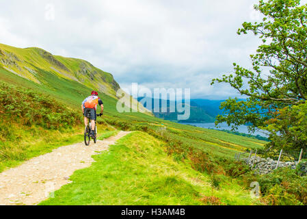 Mountain biker above Ullswater in the Lake District Cumbria England Stock Photo
