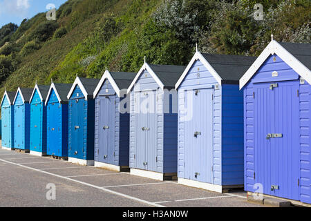 Shades of blue beach huts on promenade between Boscombe and Bournemouth, Dorset UK in October Stock Photo