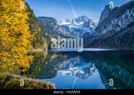 Dachstein mountain summit reflecting in crystal clear Gosausee mountain in fall, Salzkammergut region, Upper Austria, Austria Stock Photo