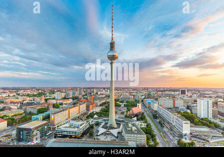 Berlin skyline panorama with famous TV tower at Alexanderplatz and dramatic clouds at sunset, Germany