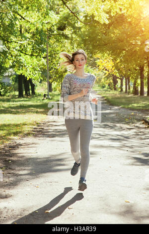 Young girl with blue eyes a joging in the park Stock Photo