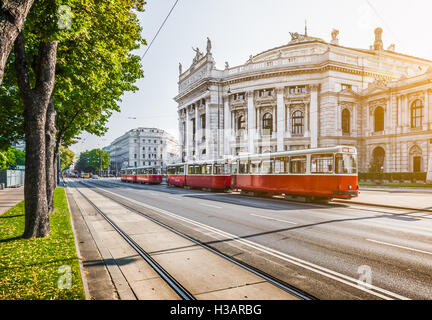 Wiener Ringstrasse with historic Burgtheater (Imperial Court Theatre) and traditional  electric tram at sunrise, Vienna, Austria Stock Photo