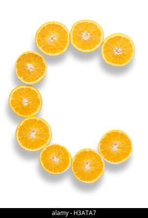 Vitamin C letter made from orange halves over a white background Stock Photo