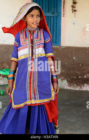 BHUJ, INDIA - JANUARY 13: The young girl in the ethnic dress from the Gujarat state is going for water to the desert, Bhuj