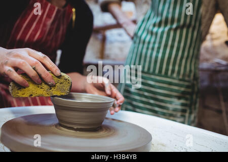 Craftsmen working in pottery workshop Stock Photo