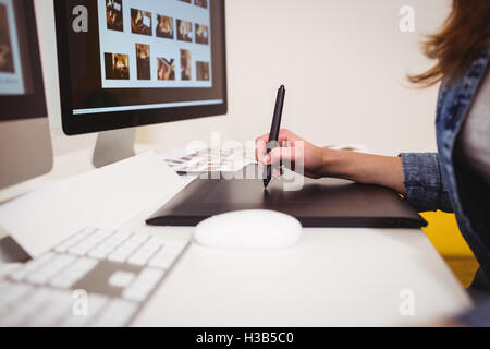 Midsection of photo editor using graphics tablet Stock Photo