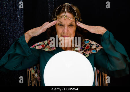 Fortune teller with crystal ball Stock Photo