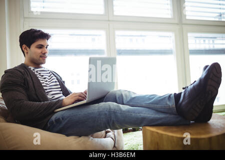 Relaxed photo editor using laptop Stock Photo