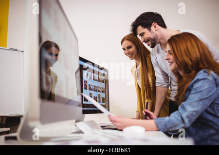 Smiling photo editors working on computers Stock Photo