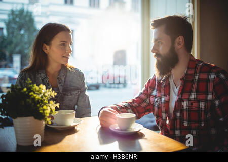 Young couple communicating at cafe Stock Photo