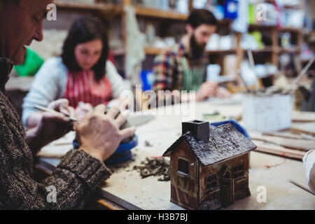 Mature male potter working with colleagues Stock Photo