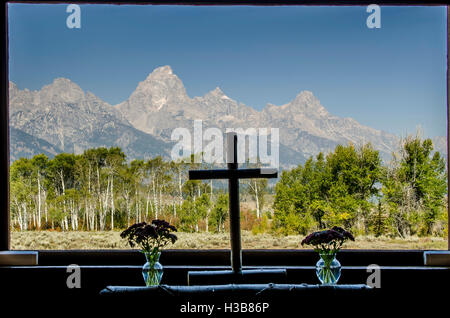 Tetons cross altar window in the Episcopal Chapel of the Transfiguration, Grand Teton National Park, Wyoming, USA. Stock Photo