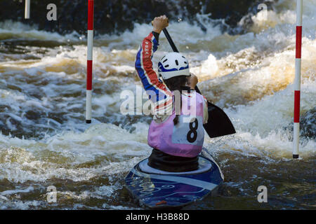 Female white water canoeist competing in the Canoe Wales National Slalom at the National White Water Centre on the River Tryweryn Frongoch North Wales Stock Photo