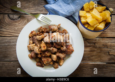 Portion Of Fried Greaves On Black Plate On Dark Background. Homemade 