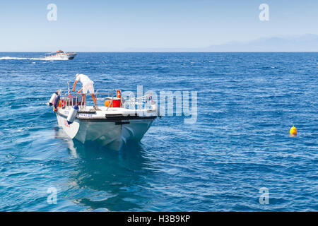 Zakynthos, Greece - August 20, 2016: White pleasure boat floating on sea water in summer day Stock Photo