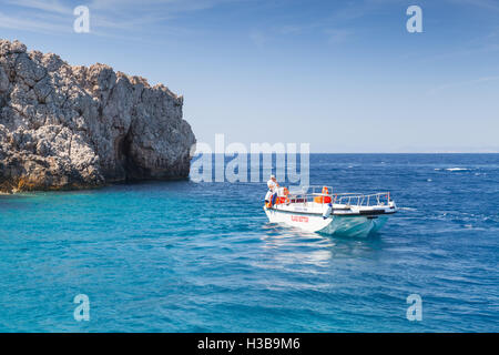 Zakynthos, Greece - August 20, 2016: White pleasure boat with skipper floating on sea water in summer day Stock Photo