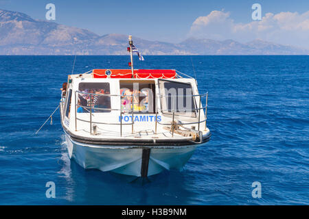 Zakynthos, Greece - August 20, 2016: Small pleasure boat with tourists goes on sea water in summer day, front view Stock Photo