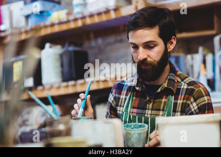 Bearded man working in workshop Stock Photo