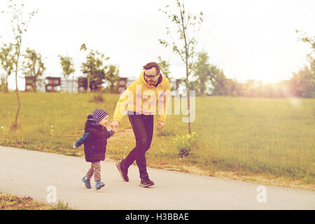 happy father and little son walking outdoors Stock Photo