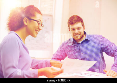 smiling team with paper at office Stock Photo