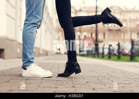 Close up of legs of kissing couple Stock Photo - Alamy