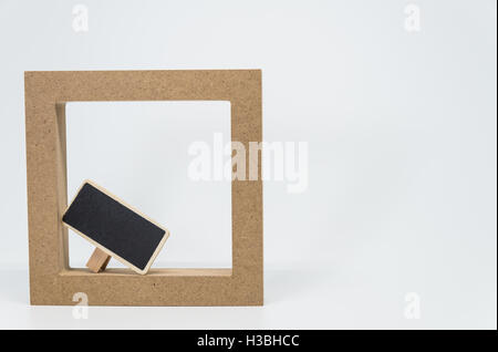 Wooden frame border and small black board with white background and selective focus Stock Photo