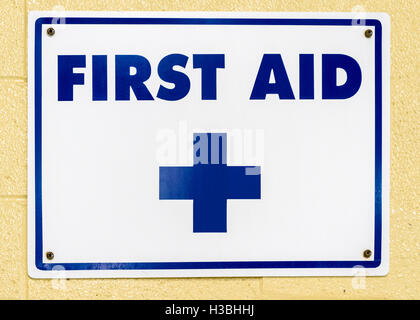 First aid sign on a concrete wall. Stock Photo