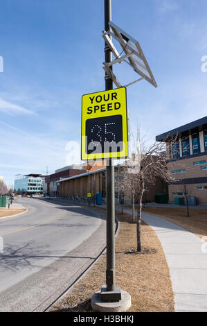 Solar-powered speed indicator sign on a residential street. The sign has a sensor that warns motorists who exceed the residentia Stock Photo