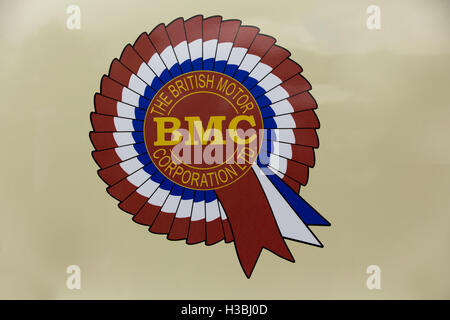 Iconic emblem of the British Motor Corporation. BMC. The brand disappeared in 1968 to become British Leyland. Distinct rosette on a beige background. Stock Photo
