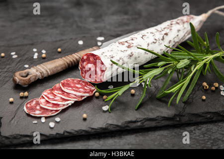 Delicious smoked salami sausage with salt, spices and herbs cut into ...