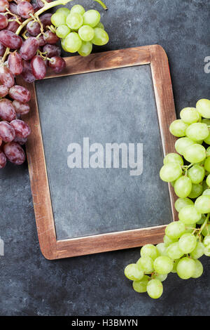 Red and white grapes and chalkboard for your text. Top view with copy space Stock Photo
