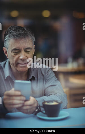 Man text messaging on mobile phone Stock Photo