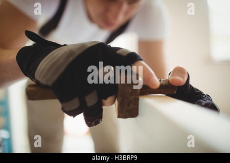Carpenter using marking gauge on a wooden door Stock Photo