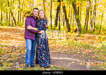 love, relationship, family and people concept - couple in autumn park Stock Photo