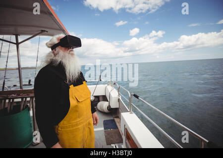 Fisherman using virtual reality glasses Stock Photo