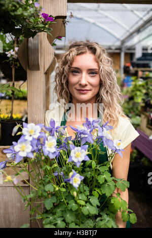 Female florist holding a potted plant Stock Photo