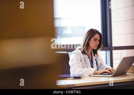 Female doctor using laptop at her desk Stock Photo