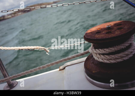 Rope tied to bollard on boat deck Stock Photo
