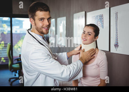 Physiotherapist examining a female patient's neck Stock Photo