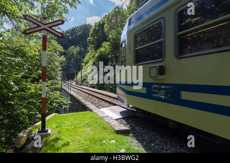 A rail crossing in Borgnone with Centovalli's train passing by, Centovalli, Canton Ticino, Switzerland Stock Photo
