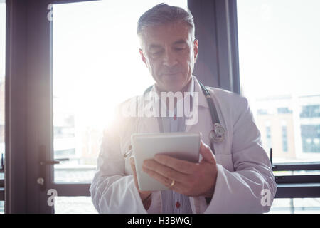Doctor with stethoscope using digital tablet Stock Photo