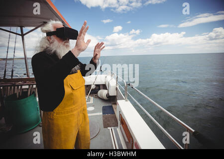 Fisherman using virtual reality glasses Stock Photo
