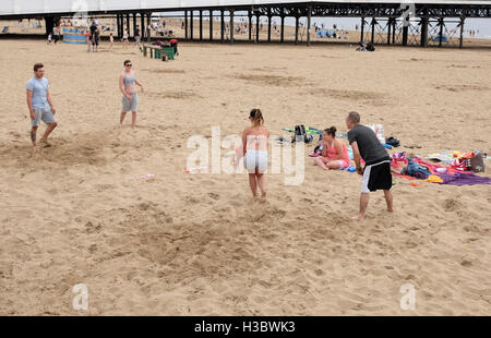 17th July 2016, group of young people playing volley ball on a beach without a net at Weston super Mare. Stock Photo