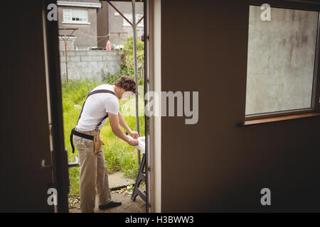 Carpenter measuring a door frame Stock Photo