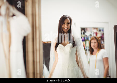 Woman trying on wedding dress in a shop Stock Photo
